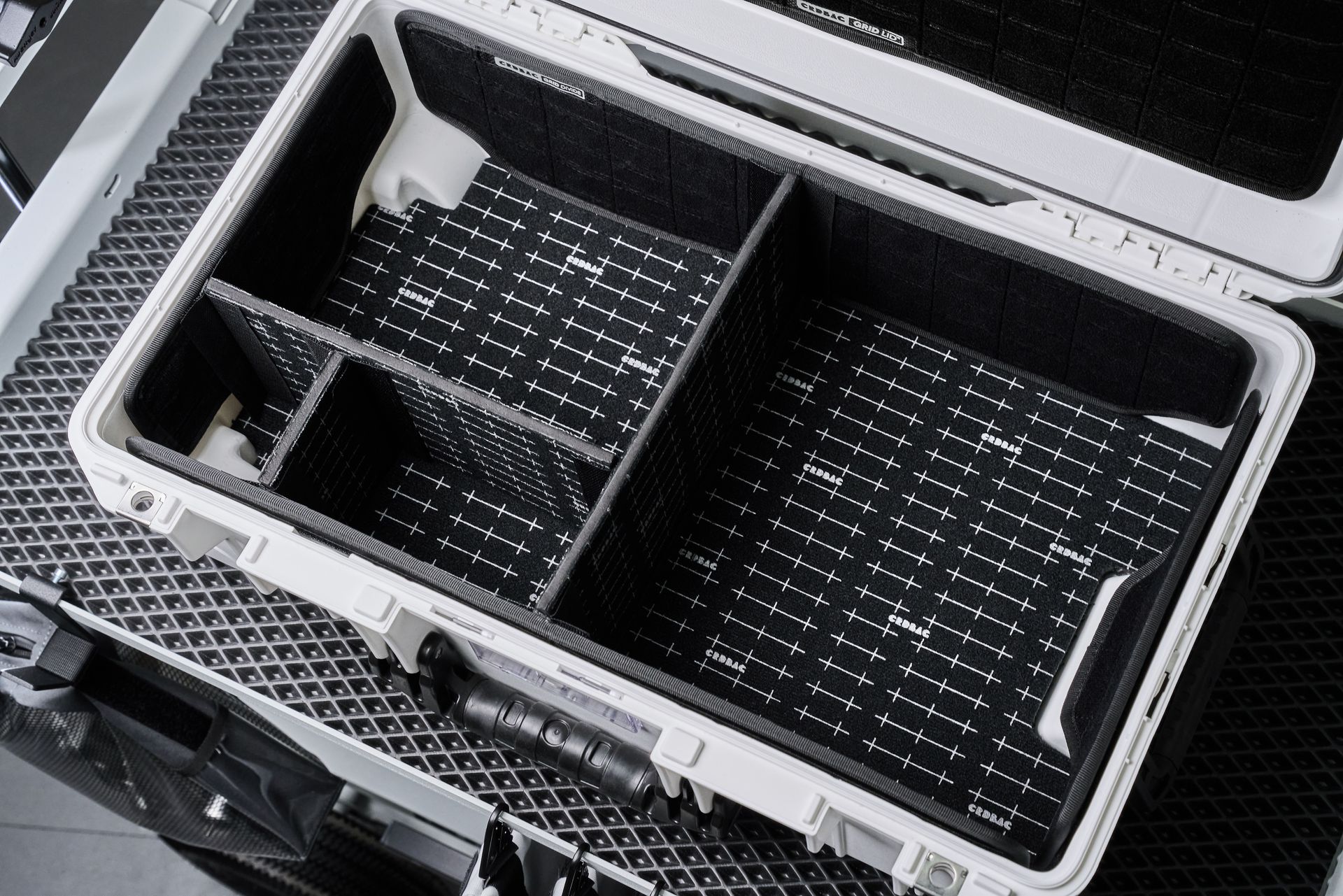 Top view of an open hardcase with customizable compartments for organizing camera equipment.